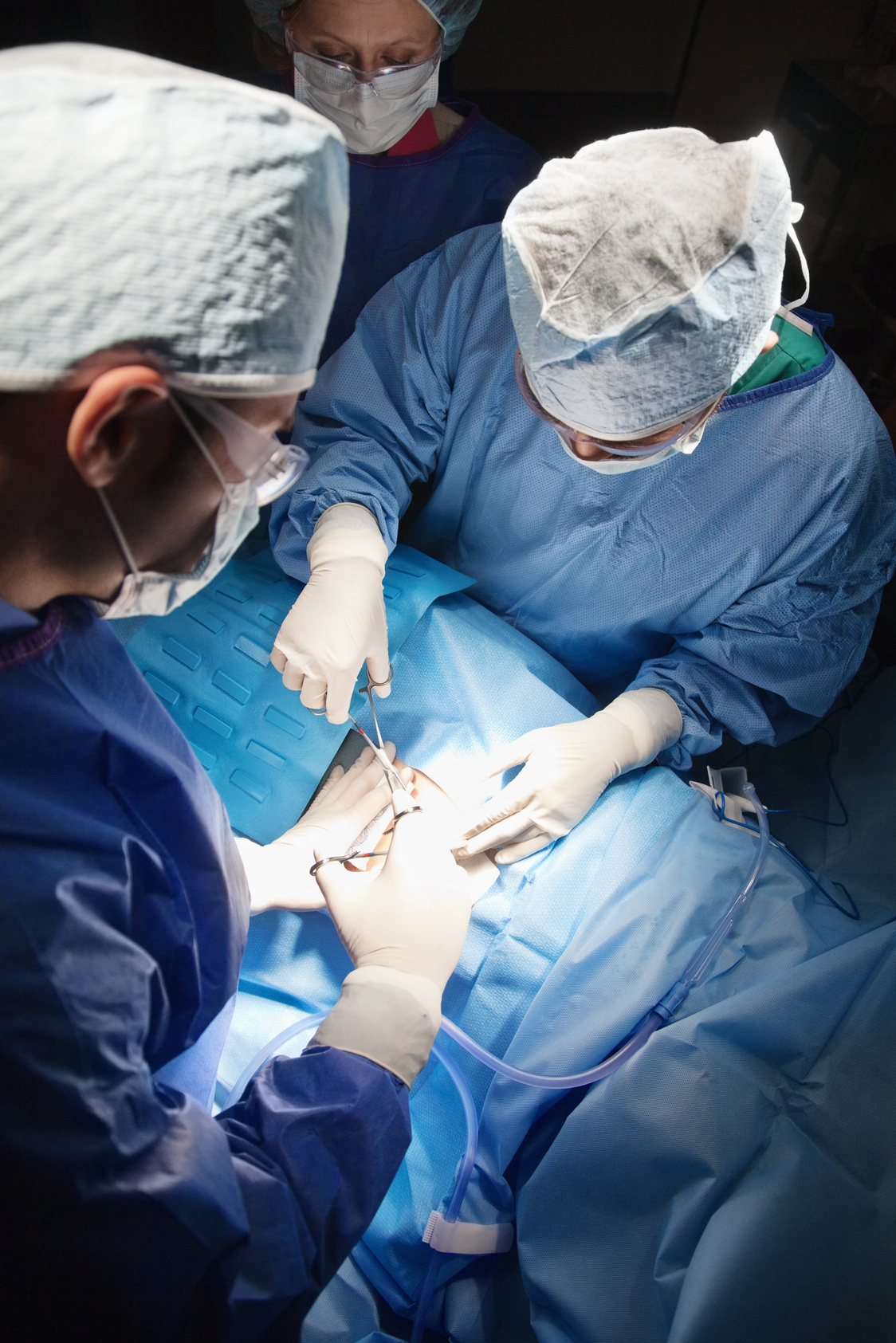 Surgeons preparing patient for cesarean section procedure